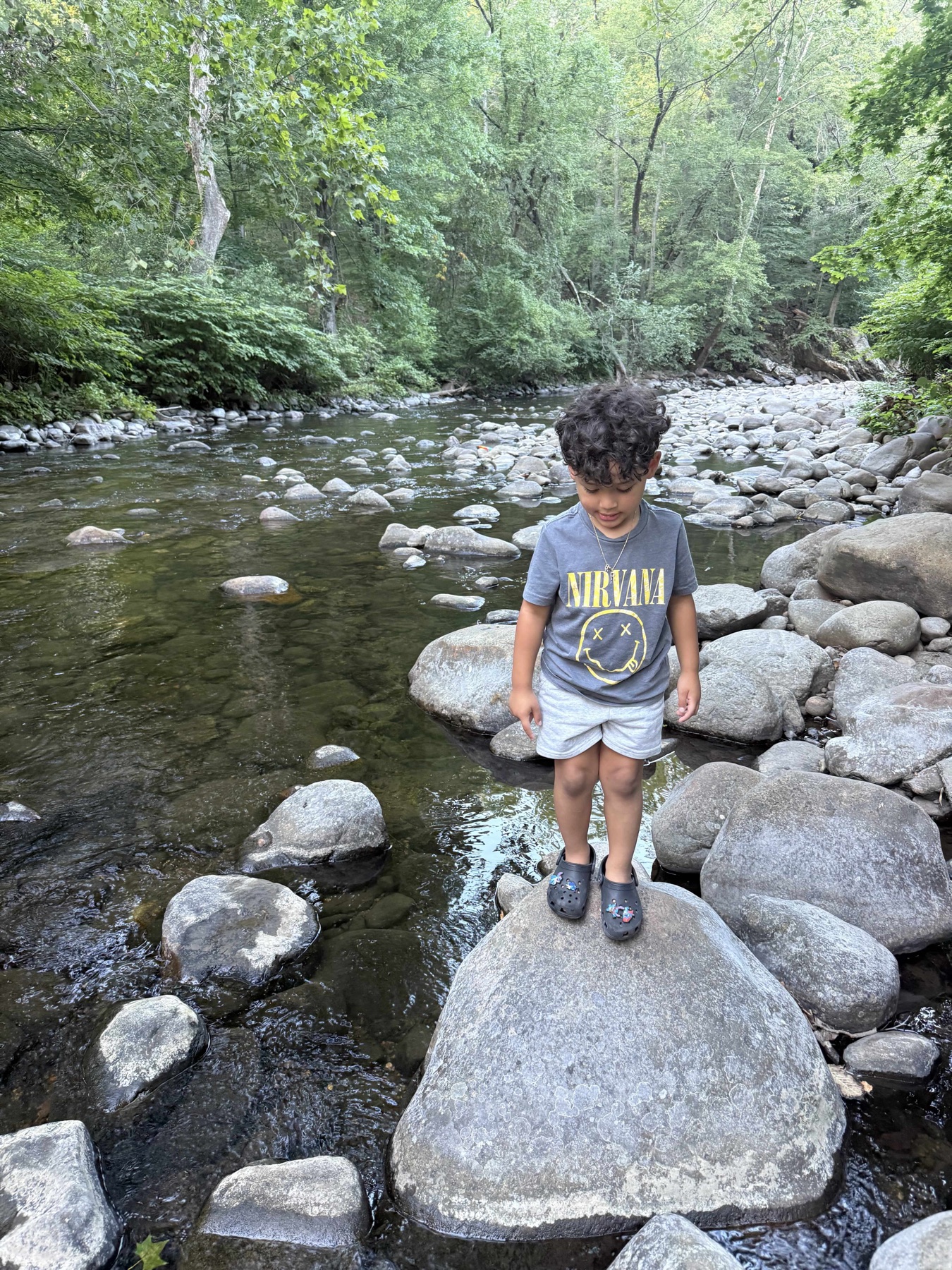 Child exploring the rocky brook